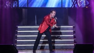 a man singing at the stage